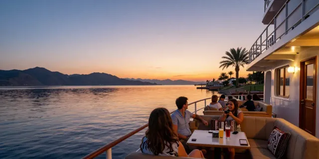 Relaxing Lake Nasser Cruises experience with a traveler enjoying the sunset view from a luxurious cruise ship deck.
